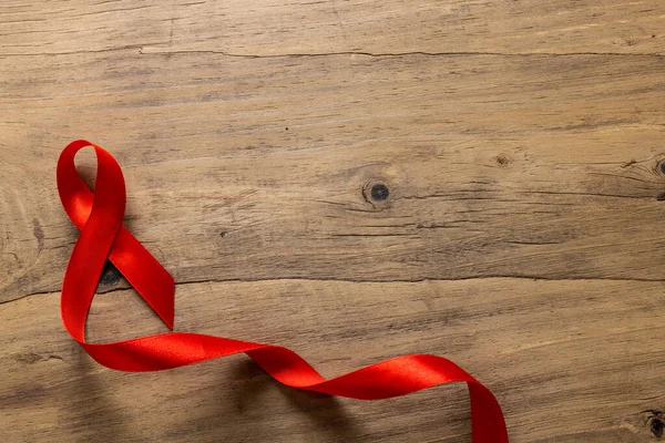 Directly Shot Single Red Aids Awareness Ribbon Wooden Table Copy — стоковое фото