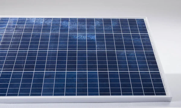 High angle view of blue solar panel with grid patterns isolated against white background, copy space. solar energy, electricity, green technology and sustainability concept.