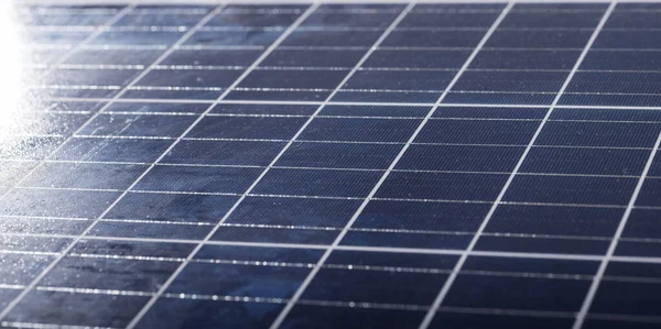 Full frame shot of white grid patterns on blue solar panel, copy space. solar energy, electricity, green technology and sustainability concept.