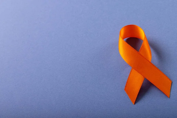 Overhead View Orange Leukemia Awareness Ribbon Isolated Blue Background Copy — Stock Photo, Image