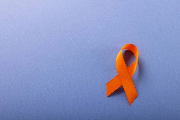 Overhead View Orange Leukemia Awareness Ribbon Isolated Blue Background Copy — Stock Photo, Image