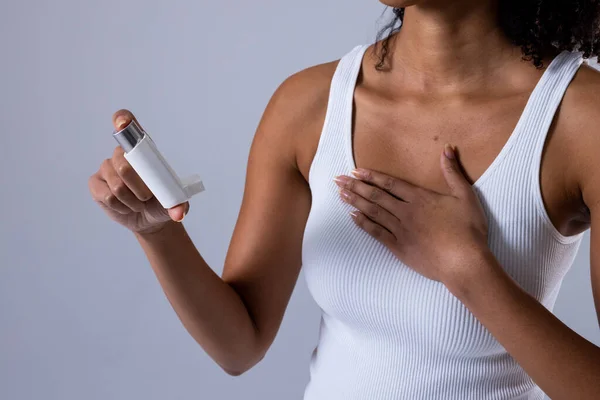 Midsection African American Mid Adult Woman Holding Asthma Inhaler White — Stockfoto