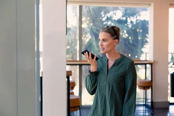 Caucasian Female Advisor Talking Smartphone Speaker Modern Workplace Unaltered Business — Stock Photo, Image