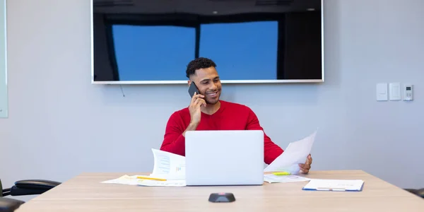 Smiling Young Hispanic Businessman Talking Smartphone While Analyzing Document Boardroom — Zdjęcie stockowe