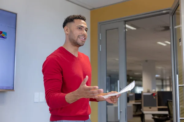 Confident Hispanic Male Professional Holding Document While Explaining Strategy Modern — Photo