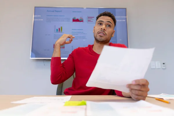 Confident Hispanic Male Advisor Pointing Television Screen While Giving Presentation — Stockfoto