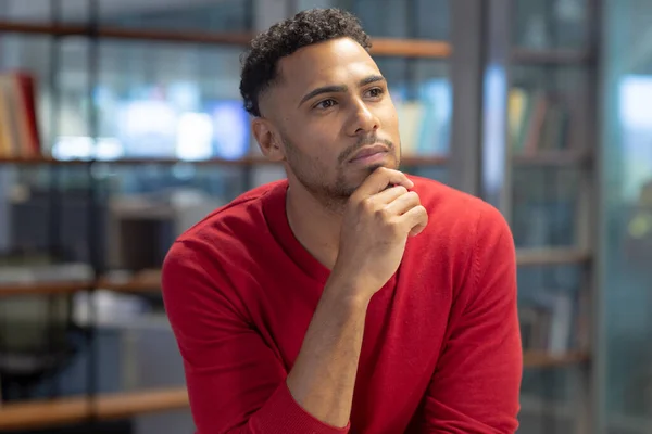 Thoughtful Hispanic Businessman Hand Chin While Looking Away Modern Workplace —  Fotos de Stock