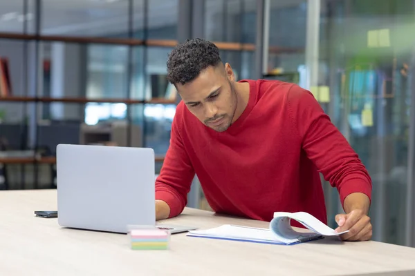 Hispanic Male Advisor Analyzing Document While Sitting Laptop Modern Workplace — Photo
