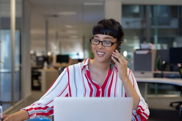 Smiling Biracial Businesswoman Talking Mobile Phone While Sitting Laptop Workplace — Stock Photo, Image