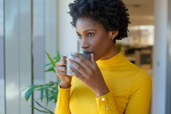 Young African American Businesswoman Staring While Drinking Coffee Mug Modern — стокове фото