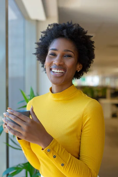 Portrait Cheerful Young African American Businesswoman Holding Coffee Mug Workplace — стоковое фото