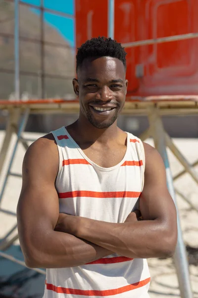Portrait Smiling African American Young Man Arms Crossed Standing Beach — Stock Photo, Image