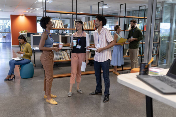 Smiling Multiracial Colleagues Discussing While Standing Together Modern Workplace Unaltered Stock Image