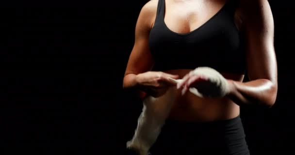 Unsmiling Muscular Woman Wearing Bandage Black Background — Stock Video