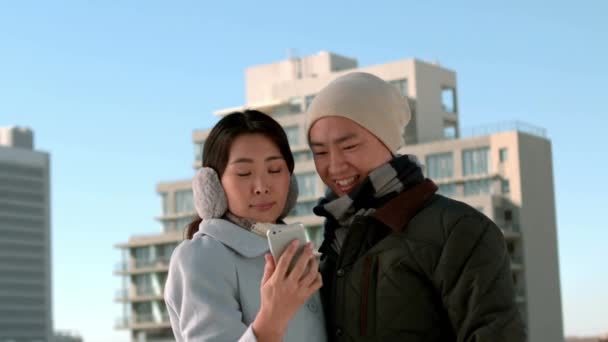 夫妇在慢动作穿暖和的衣服通告电话 — 图库视频影像