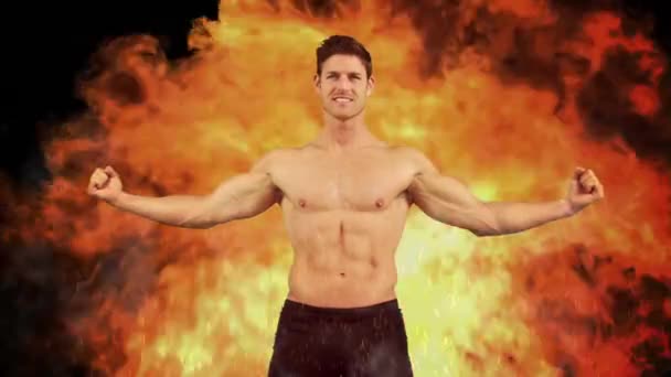 Apto Homem Flexionando Bíceps Fundo Flamejante — Vídeo de Stock