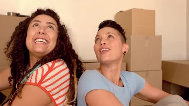 Happy Lesbian Couple Sitting Floor Looking New House Slow Motion — Stock Video