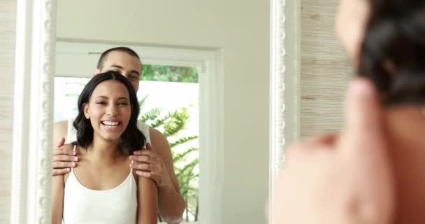 微笑对年轻的夫妇前面的卧室里的镜子 — 图库视频影像