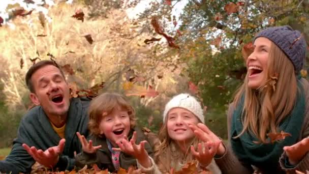 Famille Heureuse Amuser Avec Des Feuilles Tombant Autour Eux — Video