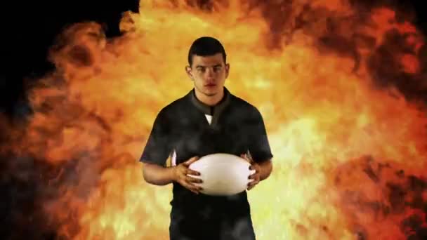 艰难的橄榄球球员握球上火红的背景 — 图库视频影像