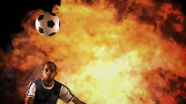 足球运动员把球踢上火红的背景 — 图库视频影像