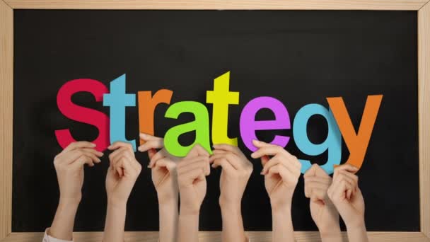 Hands Holding Strategy Blackboard Background — Stock Video