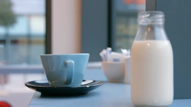 Κανάτα Γάλακτος Και Κύπελλο Στο Τραπέζι Του Καφέ Μορφή Υψηλής — Αρχείο Βίντεο