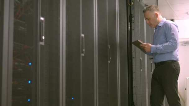 Technician Using Tablet While Analysing Server High Quality Format — Stock Video