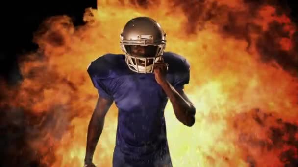 美式足球球员握球上火红的背景 — 图库视频影像