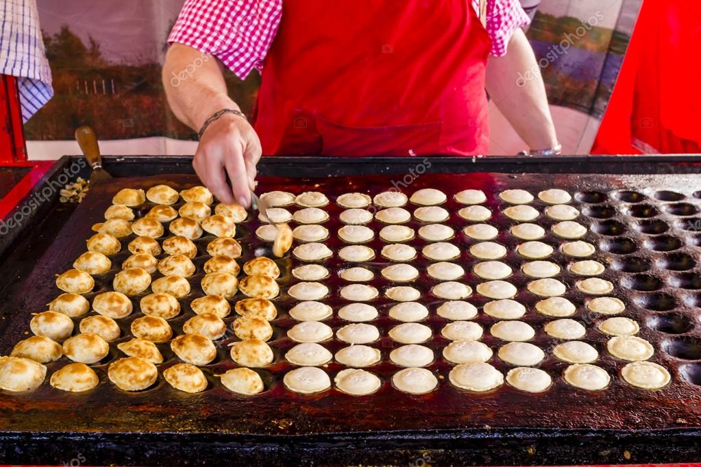 Freshly baked traditional Dutch mini pancakes called "poffertjes Stock