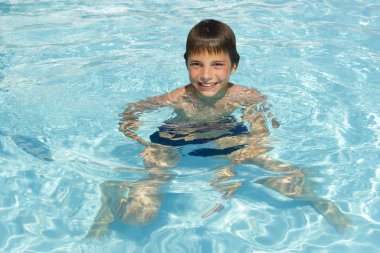 Activities on the pool. Cute boy swimming and playing in water i clipart