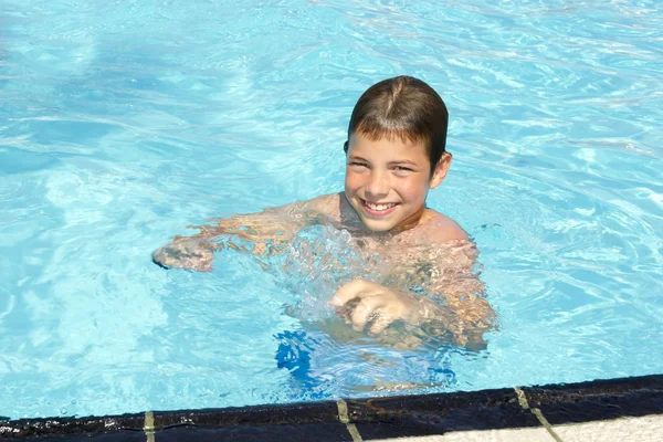 Activities on the pool. Cute boy swimming and playing in water i — Stock Photo, Image