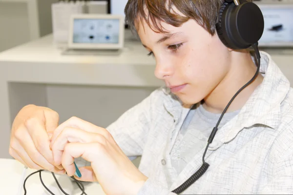 Porträt eines süßen Jungen, der über Kopfhörer Musik hört — Stockfoto