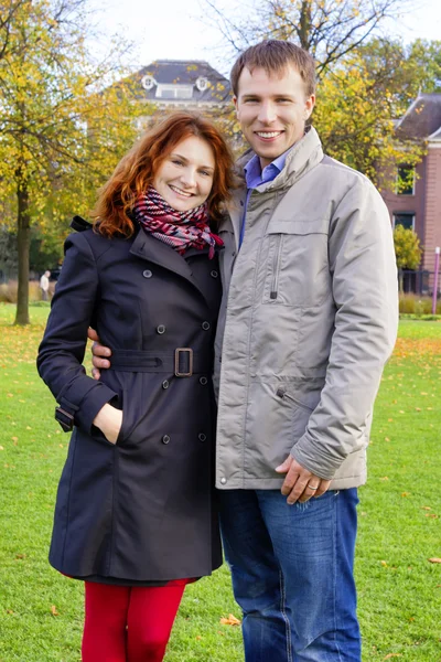 Outdoor happy couple in love posing against autumn Amsterdam bac — Stock Photo, Image