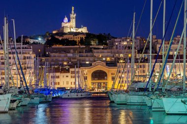 Notre Dame de la Garde and yachts in the old port in Marseille, France