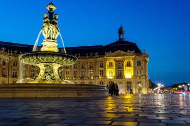 View on famous of the Place de La Bourse square with fountain in Bordeaux at dusk, Gironde, France