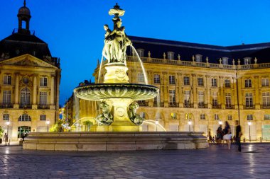 View on famous of the Place de La Bourse square with fountain in Bordeaux at dusk, Gironde, France