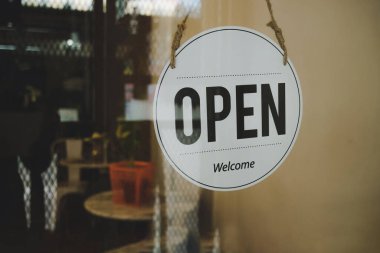 Reopen, coffee cafe shop text on vintage sign board hanging on glass door in cafe shop reopen after coronavirus quarantine is over in restaurant ready to service, small business owner concept