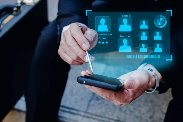 Leadership. business man in black suit using digital mobile phone with graphic virtual global business network connection diagram, teamwork, networking security, internet, communication concept