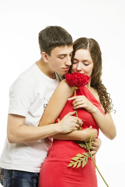 Happiness young love couple with a flower on a white background — Stock Photo, Image