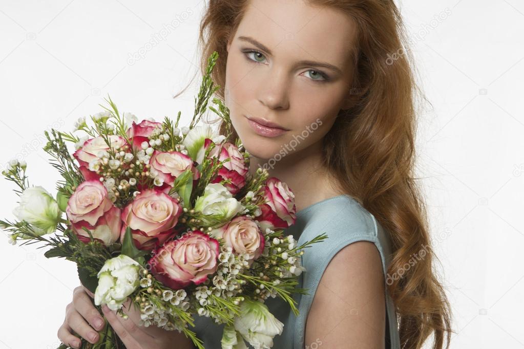 beautiful girl with a bouquet of flowers on a white background