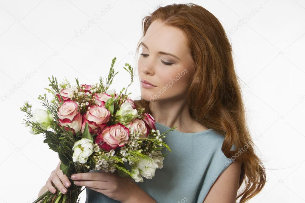 beautiful girl with a bouquet of flowers on a white background