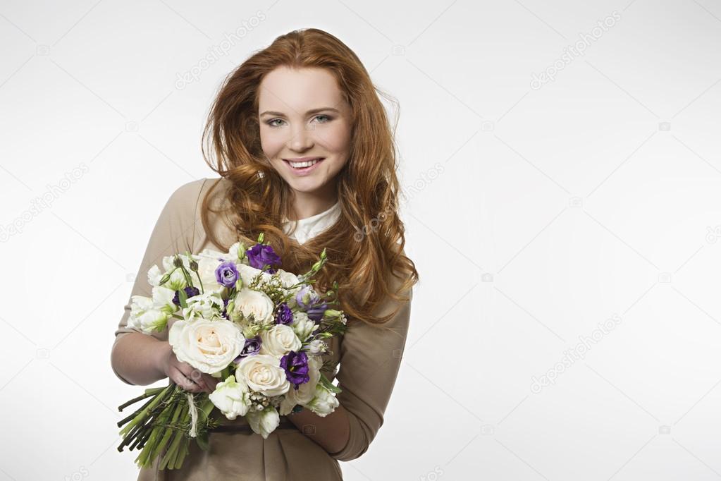 beautiful smiling girl with a bouquet of flowers on a white background