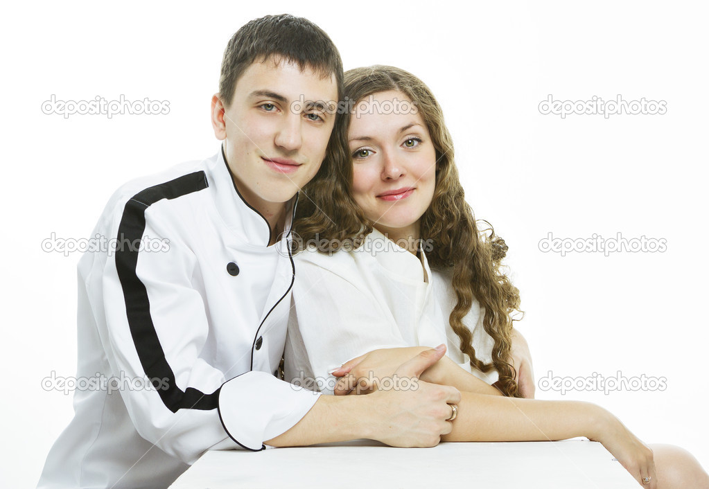 Happy young couple on a kitchen on white background