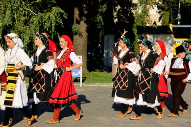 TULCEA, ROMANIA - AUGUST 08: Macedonian group of dancers in traditional costumes at the International Folklore Festival for Children and Youth - Golden Fish on August 08, 2022 in Tulcea, Romania