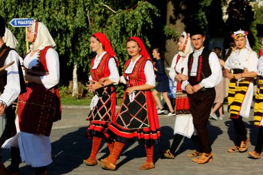 TULCEA, ROMANIA - AUGUST 08: Macedonian group of dancers in traditional costumes at the International Folklore Festival for Children and Youth - Golden Fish on August 08, 2022 in Tulcea, Romania