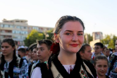 TULCEA, ROMANIA - AUGUST 08: Romanian dancer in traditional costume at the International Folklore Festival for Children and Youth - Golden Fish on August 08, 2022 in Tulcea, Romania