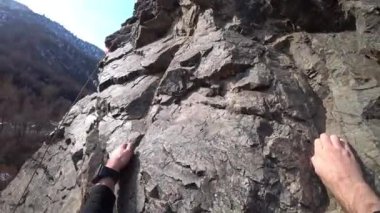 Rock climbing in the first person. The guy goes up