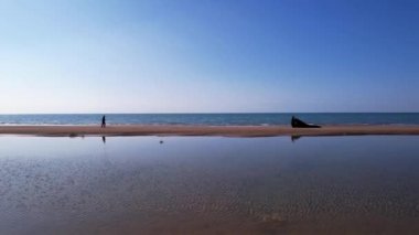 A guy and girl on beach are running to each other