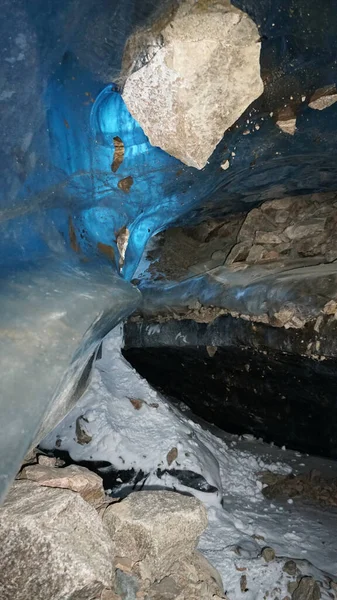Det finns stenar och is inne i isgrottan. — Stockfoto